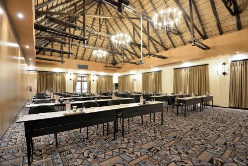 a large banquet hall with tables and chairs at Kwa Maritane Lodge in Ledig