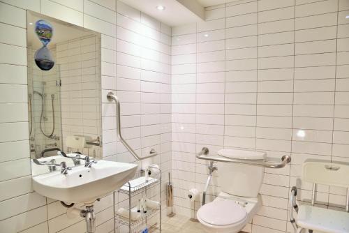 a bathroom with a toilet and a sink at The Portswood Hotel in Cape Town
