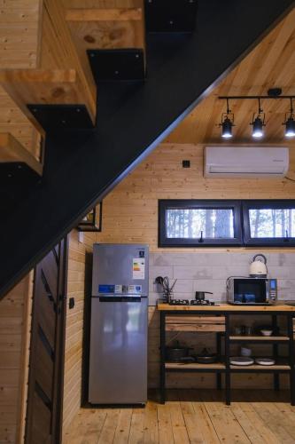 a kitchen with a stainless steel refrigerator and a counter at Park Hotel Surami Chalet in Surami