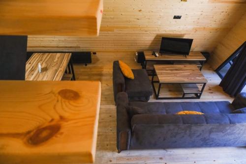 a living room with a couch and a table at Park Hotel Surami Chalet in Surami