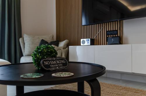 a living room with a table and a couch at Green apartment in Piraeus