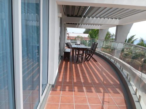 a balcony with a table and chairs on it at Heavenly Hideaway in Nilaveli