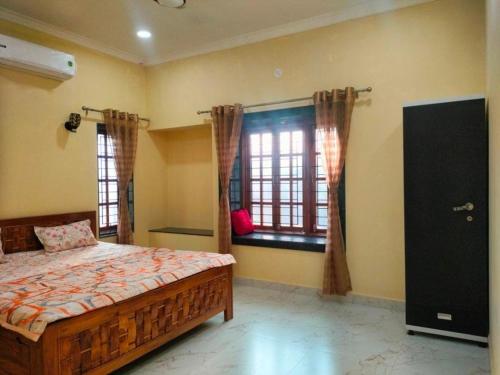 a bedroom with a bed and a window at Anay's Homely Hideout in Davorlim