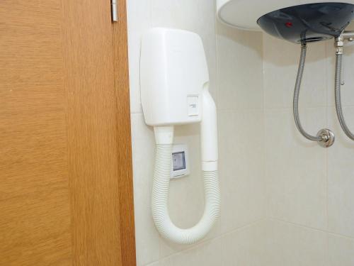 a white phone hanging on a wall in a bathroom at Lavender Suite Zadar in Zadar