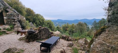 a bench sitting on top of a rocky hill at Rifugio Ortobene in Nuoro