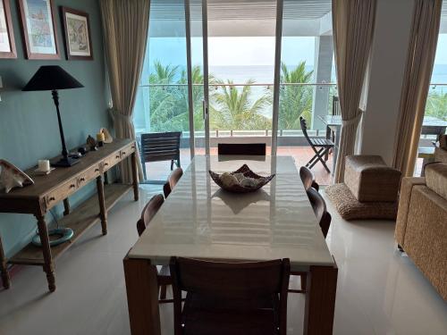 a living room with a table and a view of the ocean at Heavenly Hideaway in Nilaveli