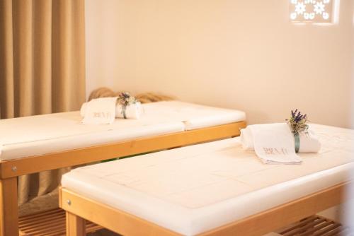 two beds in a room with white sheets at Marenea Suite Hotel - CDSHotels in Marittima