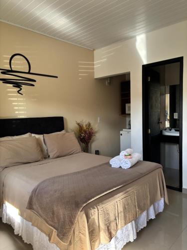 a bedroom with a large bed in a room at Espaço Praia - Suíte 101 in Angra dos Reis