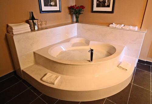 a large white bath tub in a bathroom at Century Casino & Hotel Edmonton in Edmonton