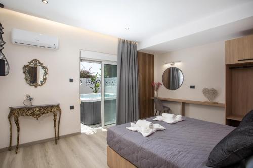 a bedroom with a bed with towels on it at JnS Premium Stay in Faliraki