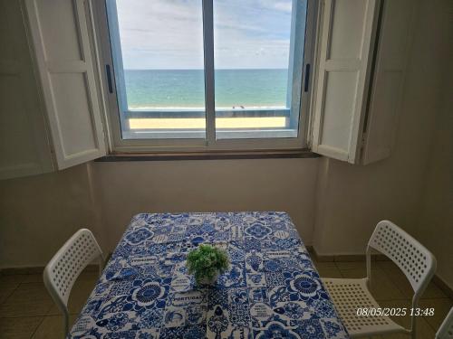 a table and two chairs with a view of the ocean at BLife Vistaya private apartment in Faro