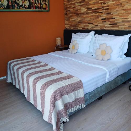 a bedroom with a large bed with flowers on it at East Meets West Bed and Breakfast in Veenendaal