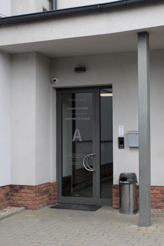 a glass door of a building with a sign on it at Apartmány Abacie in Nový Jičín