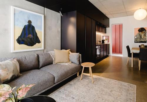 a living room with a couch and a table at NYC Loft Vibe! 2BR City Stay w Rooftop Terrace in Wellington