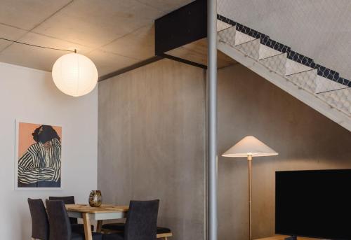 a dining room with a table and a staircase at NYC Loft Vibe! 2BR City Stay w Rooftop Terrace in Wellington