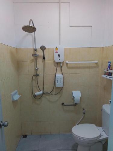 a bathroom with a toilet and a shower in it at The Rock Coco Villa in Ban Laem Pom