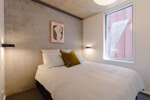 a bedroom with a white bed and a window at NYC Loft Vibe! 2BR City Stay w Rooftop Terrace in Wellington