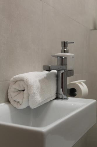 a towel sitting on top of a bathroom sink at Apartmány Abacie in Nový Jičín