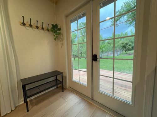 a room with a door and a bench next to a window at The Mountains are Calling - Private, Guesthouse Retreat near Yosemite in Ahwahnee