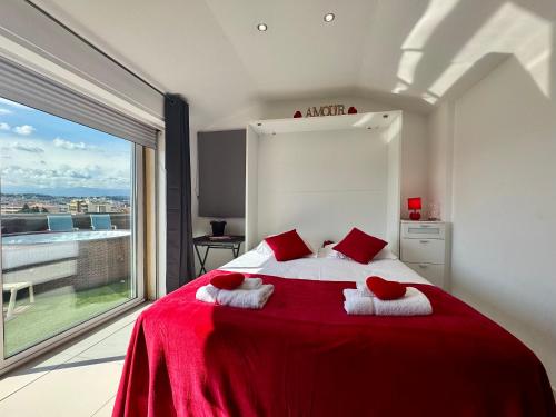 a bedroom with a red bed with red pillows and a window at Studio Love Room Rooftop Jacuzzi SCLS Rentals in Cannes