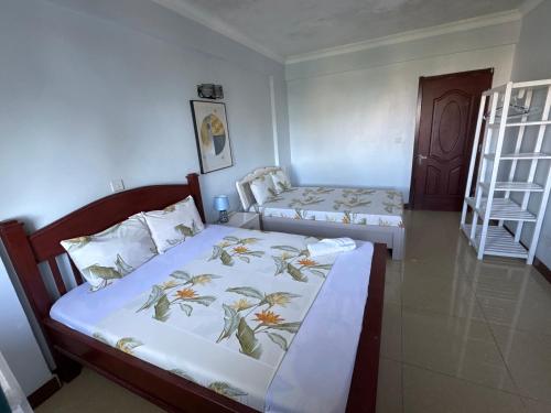 a bedroom with two beds and a ladder at Beachfront M. A.apartment in Dar es Salaam