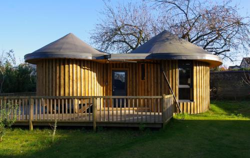 a large wooden gazebo in a yard at Fun holiday lodges in historic walled garden near Falkirk, Heart of Scotland Holidays in Falkirk