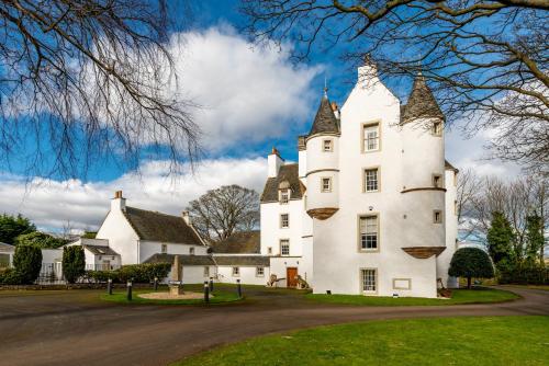 a large white building with a tower at Castle Gogar Cottage in Edinburgh