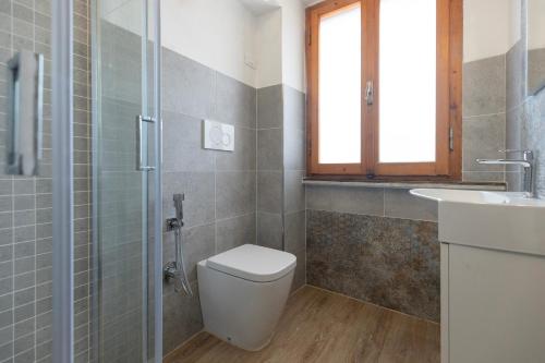 a bathroom with a toilet and a sink at Casa Fetovaia - HelloElba in Fetovaia
