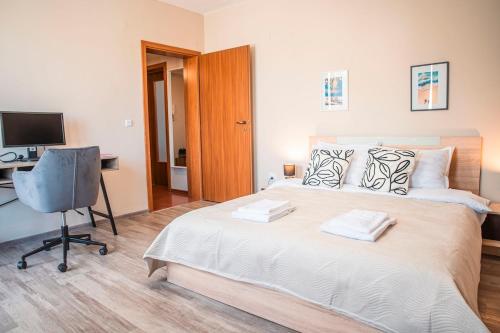 a bedroom with a bed with a desk and a computer at Breeze Atelier in Varna City