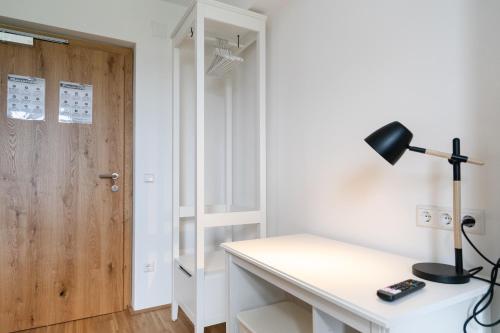 a room with a desk with a lamp and a door at Apartment Sonnleitner in Kötschach