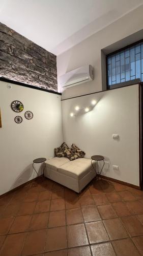 a room with a bed and two tables in it at La Casa della Guida in Nicolosi