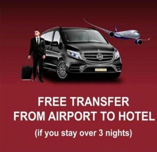 a man is standing next to a car with an airplane at Nizami by La Casa Hotel in Baku