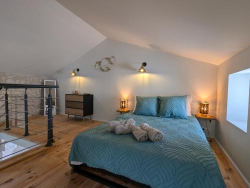 a bedroom with a bed with two towels on it at Les Pierres Douces in Champniers