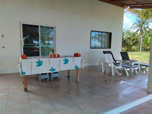 a dining room with a table and chairs in a room at The Rock Coco Villa in Ban Laem Pom