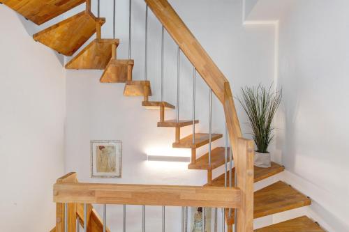 a wooden staircase in a home with a potted plant at Villa Seebrise in Göhren-Lebbin