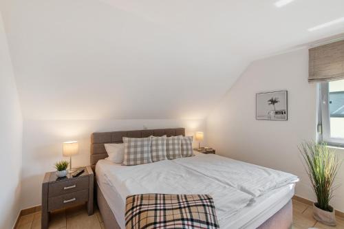 a bedroom with a large bed and a window at Villa Seebrise in Göhren-Lebbin