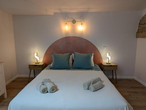 a bedroom with a large bed with towels on it at Les Pierres Douces in Champniers