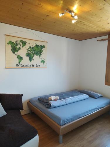 a bed in a room with a map on the wall at Ausblickszimmer in Mauren