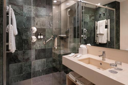a bathroom with a sink and a shower at Catalonia Atocha in Madrid