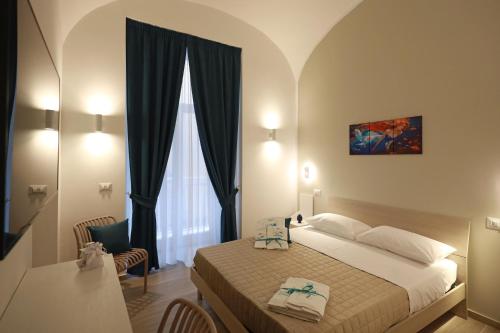 a hotel room with a bed and a window at Le chiavi di Parthenope in Naples