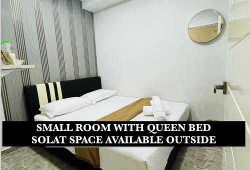 a small room with a small room with queen bed sofa space available outside at Rayyaz Inn in Kuala Terengganu