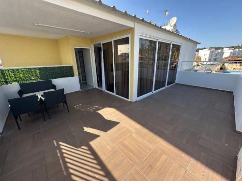 a balcony of a house with a table and chairs at Emerald Luxe in Ayia Napa