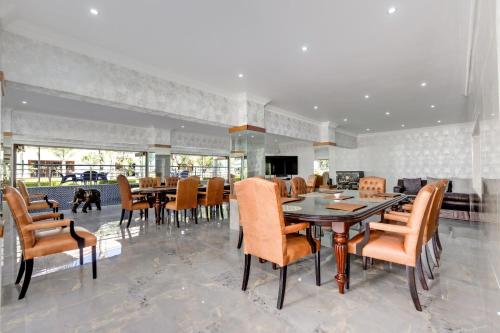 a dining room with a table and chairs at The Diplomat in Midrand