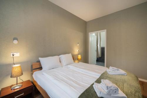 a bedroom with a large bed with towels on it at BetweenLakes Studio ground floor west in Interlaken