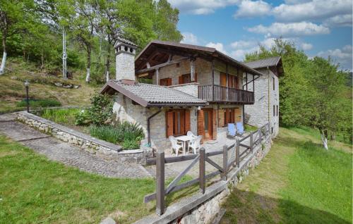 a small stone house with a fence in front of it at Awesome Home In Sovramonte With Wifi in Sovramonte