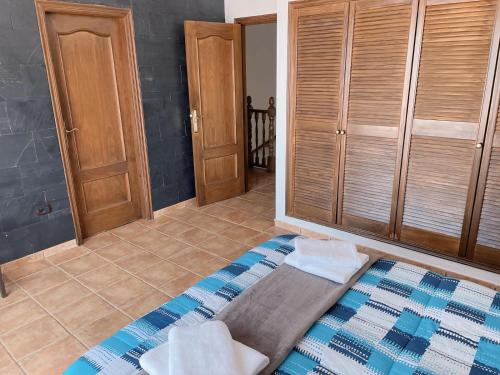 a bedroom with a bed and some wooden cabinets at Villa MarySol in Sauzal