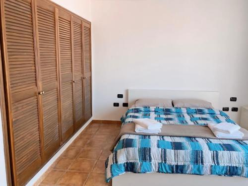 a bedroom with a bed and wooden cabinets at Villa MarySol in Sauzal