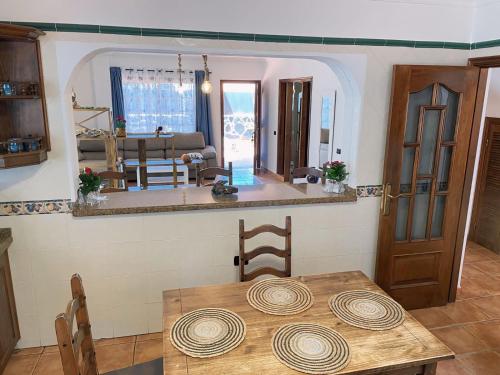 a kitchen and dining room with a wooden table at Villa MarySol in Sauzal