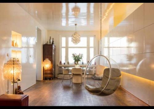a living room with a hanging chair and a table at BEAUTIFUL APARTMENT WiTH ASIAN STYLE BEDROOM NEAR RAI & CENTER in Amsterdam