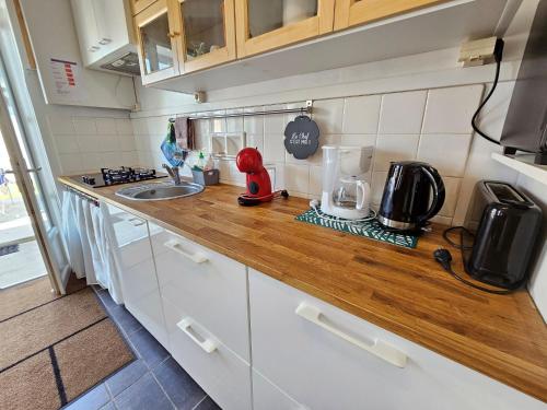 a kitchen with a counter top with a sink at La Petite Cagouille pour 4 Tonnay Charente Rochefo in Tonnay-Charente